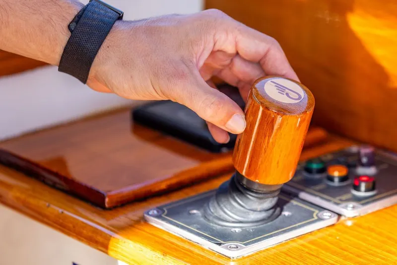 Slide: The Image of Hand operating wooden throttle on 1998 Hinckley Picnic Boat 36 Classic. - 32