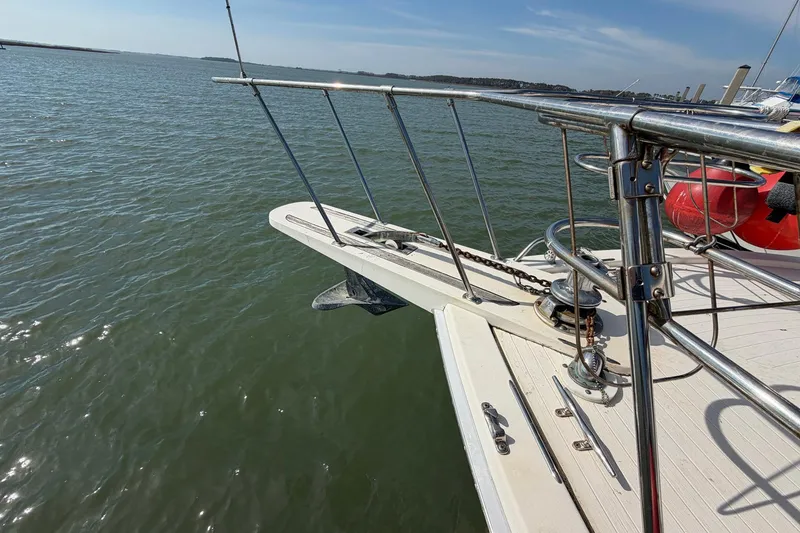 Slide: The Image of 1987 Viking 44 Motor Yacht bow with anchor, railing, and ocean view. - 9