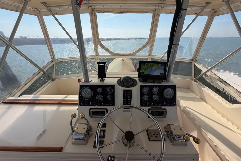 Slide: The Image of 1987 Viking 44 Motor Yacht helm with navigation equipment and ocean view. - 27