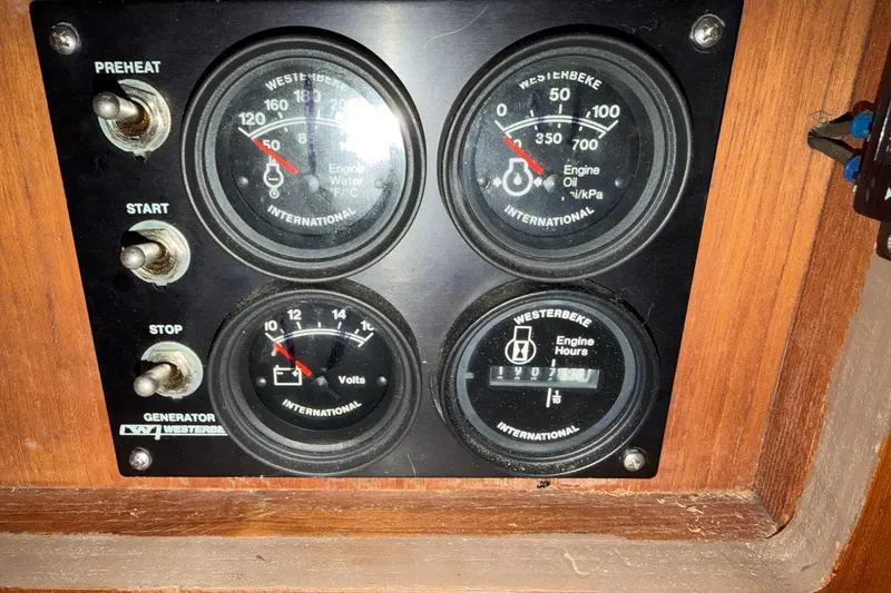 Slide: The Image of Control panel of a 1987 Viking 44 Motor Yacht with gauges and switches. - 81