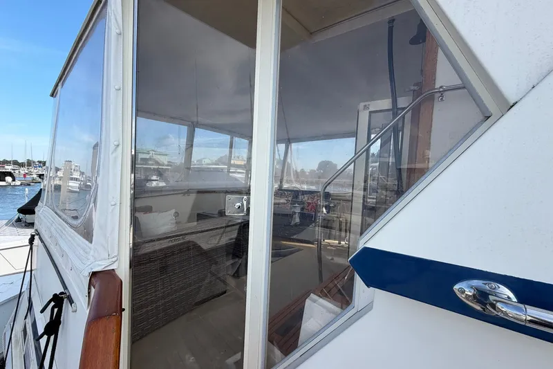 Slide: The Image of 1987 Viking 44 Motor Yacht with enclosed deck, docked at marina. - 19