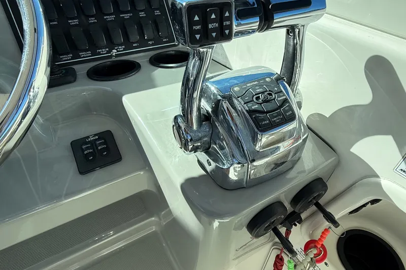 Slide: The Image of Control panel of a 2012 Boston Whaler 285 Conquest boat, featuring throttle and steering controls. - 19