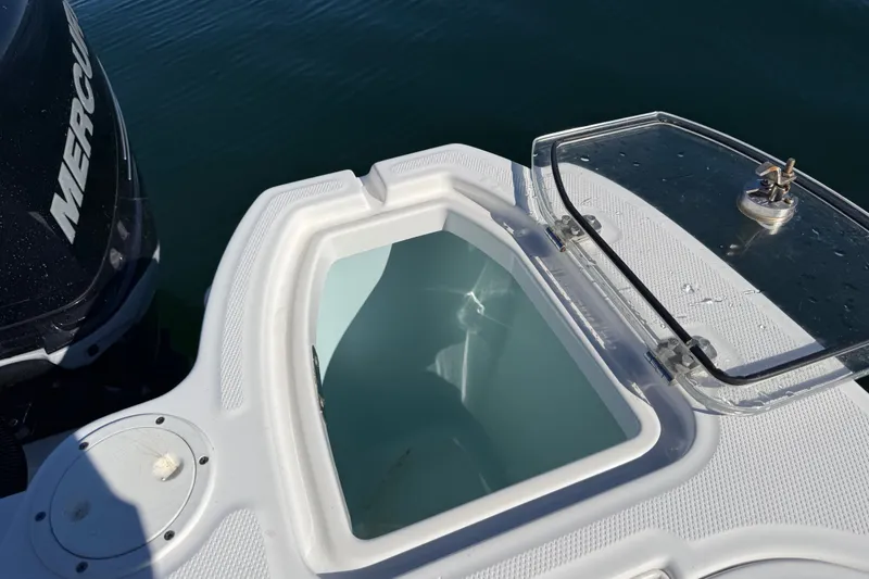 Slide: The Image of Open storage compartment on a 2012 Boston Whaler 285 Conquest boat, near Mercury engine. - 20