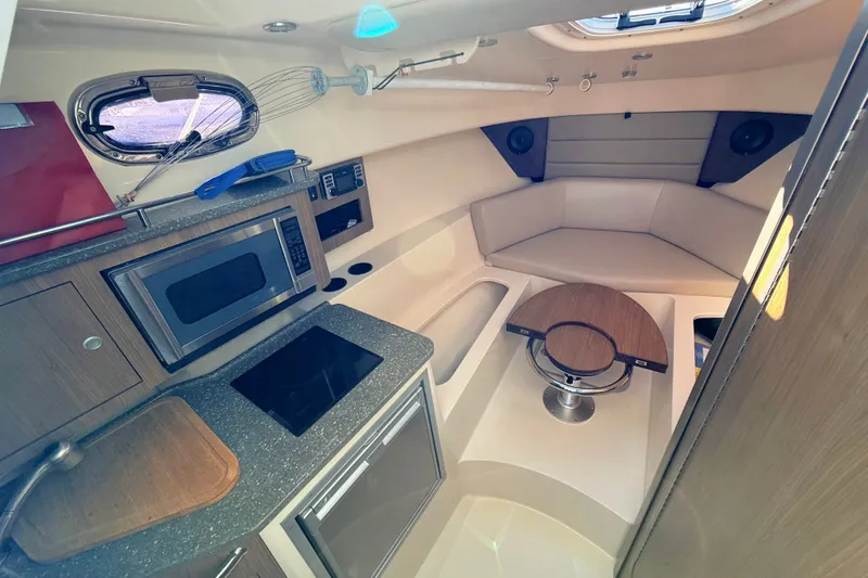 Slide: The Image of Interior of 2012 Boston Whaler 285 Conquest with kitchenette and seating area. - 21