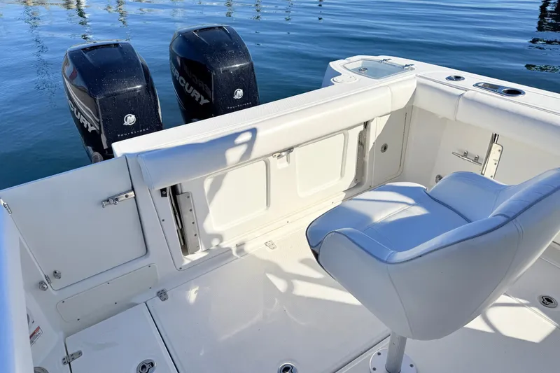 Slide: The Image of 2012 Boston Whaler 285 Conquest boat interior with dual Mercury engines. - 11
