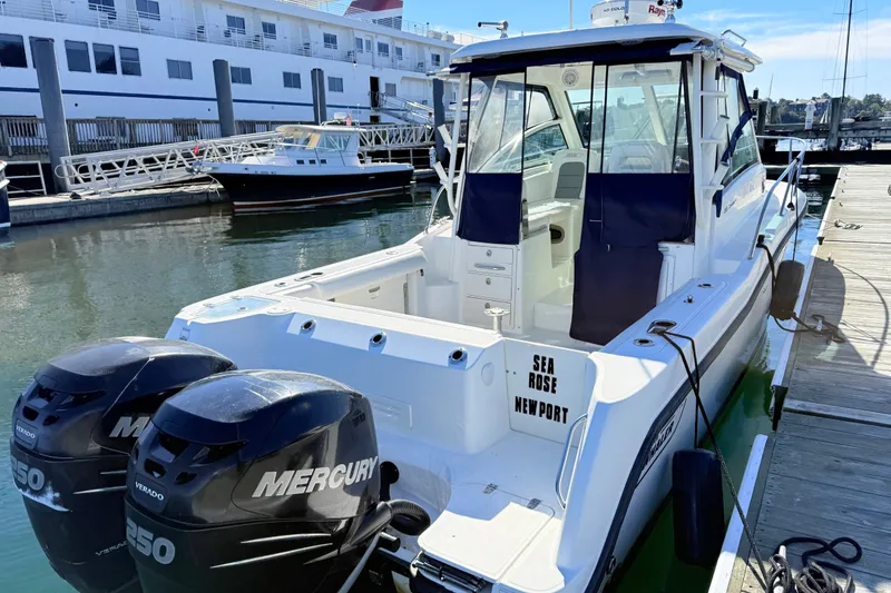 Slide: The Image of 2012 Boston Whaler 285 Conquest boat docked with twin Mercury engines. - 8