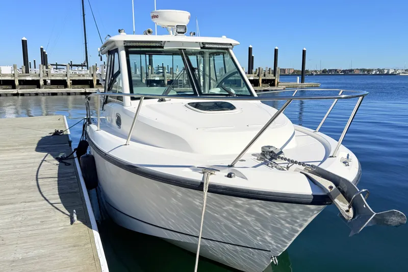 Slide: The Image of 2012 Boston Whaler 285 Conquest docked at a marina on a sunny day. - 5