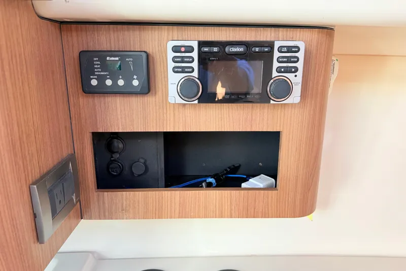 Slide: The Image of Control panel and stereo system on 2012 Boston Whaler 285 Conquest boat interior. - 24