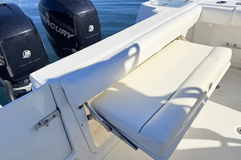 Slide: The Image of 2012 Boston Whaler 285 Conquest boat with foldable seating and dual Mercury engines. - 12