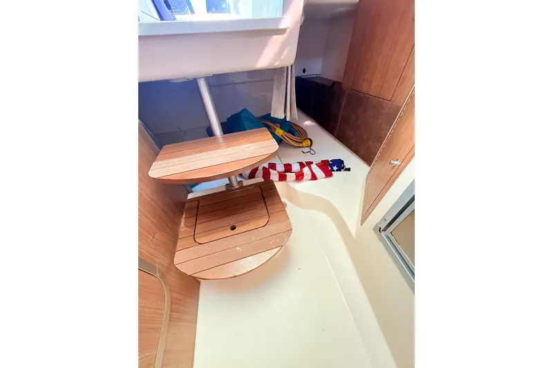 Slide: The Image of Interior of 2012 Boston Whaler 285 Conquest boat with wooden steps and storage area. - 26