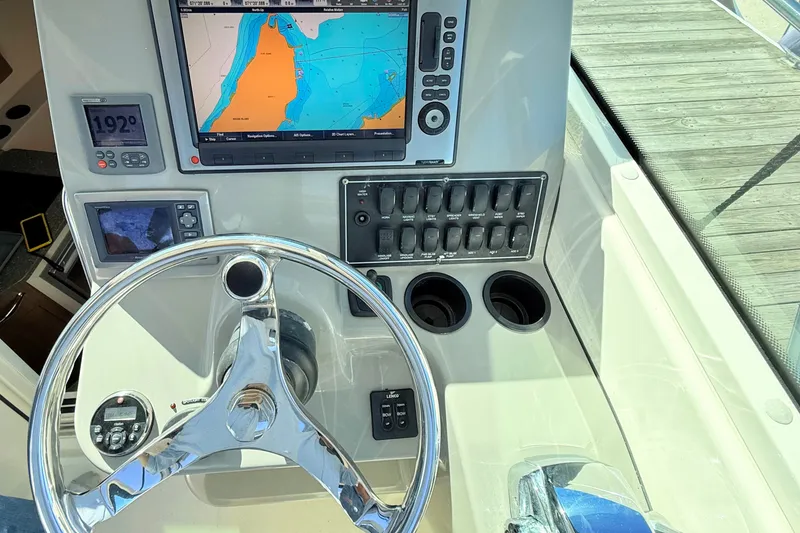 Slide: The Image of Helm of 2012 Boston Whaler 285 Conquest with navigation display and controls. - 18