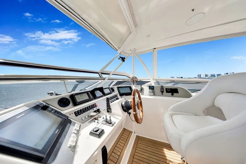 Slide: The Image of Luxurious 2007 Marquis 65 yacht helm with modern navigation equipment and plush seating. - 22
