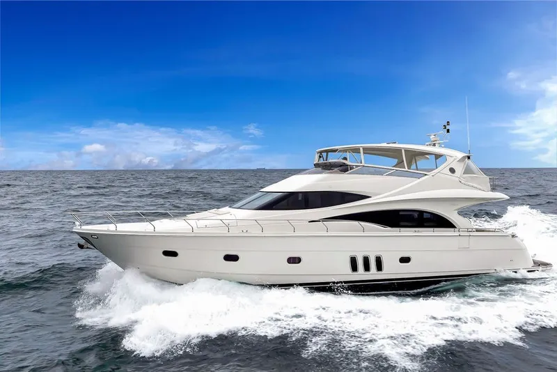 Slide: The Image of Luxury 2007 Marquis 65 yacht cruising on open sea under clear blue sky. - 9