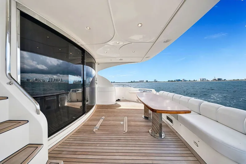 Slide: The Image of Luxurious 2007 Marquis 65 yacht deck with ocean view, featuring sleek design and spacious seating. - 17