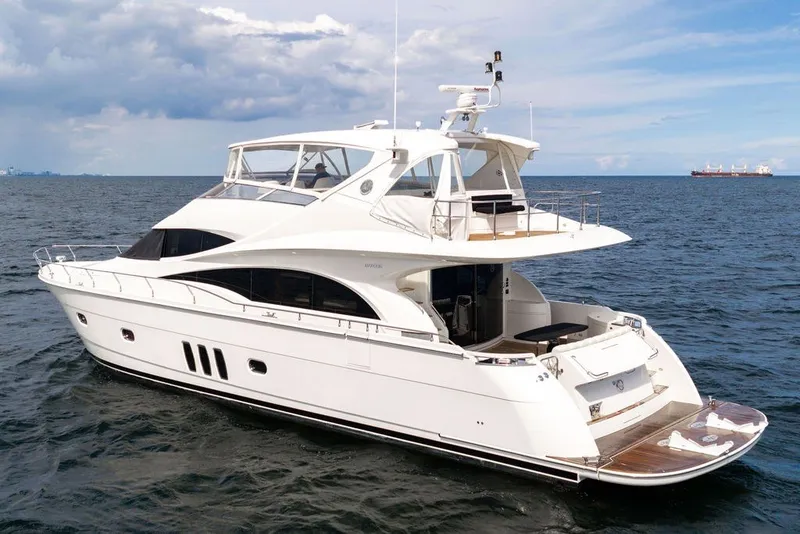 Slide: The Image of Luxury 2007 Marquis 65 yacht cruising on open sea under cloudy sky. - 14