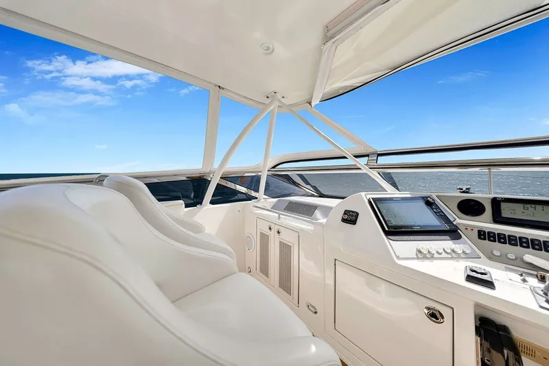 Slide: The Image of Luxurious 2007 Marquis 65 yacht cockpit with modern navigation equipment and white seating. - 21