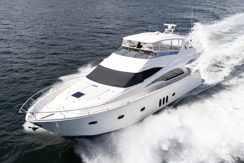 Slide: The Image of Luxury 2007 Marquis 65 yacht cruising on open water. - 12