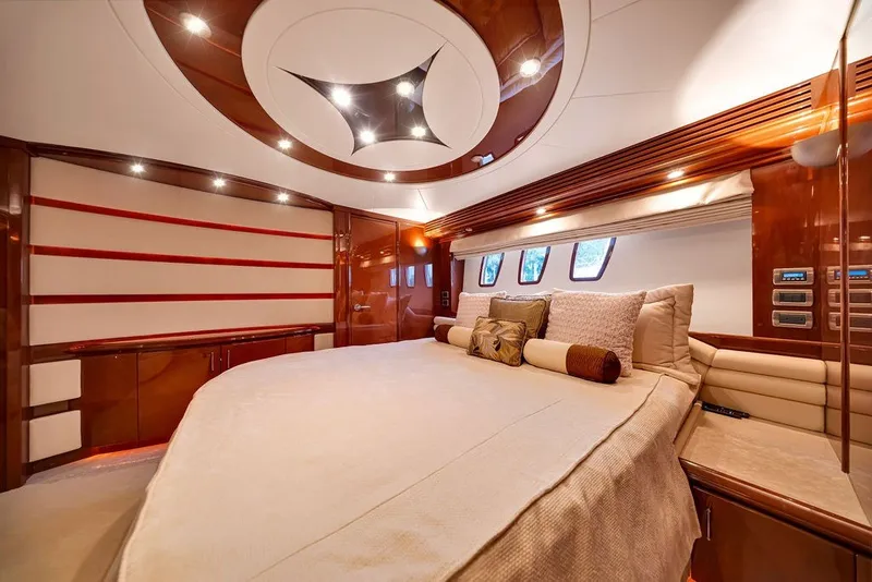 Slide: The Image of Luxurious 2007 Marquis 65 yacht bedroom with elegant wood finishes and plush bedding. - 40