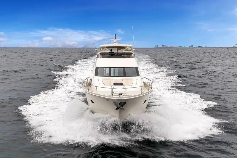 Slide: The Image of Luxury 2007 Marquis 65 yacht cruising on open water under clear blue skies. - 8