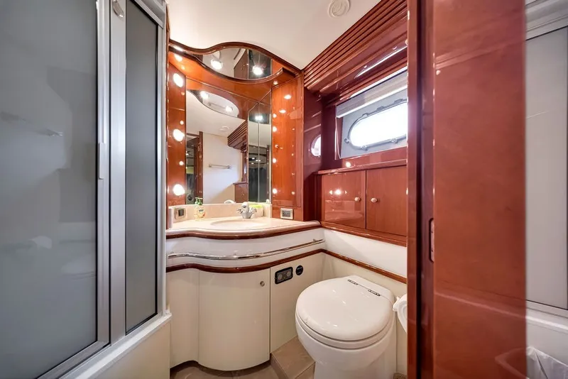Slide: The Image of Luxurious bathroom in a 2007 Marquis 65 yacht, featuring elegant wood cabinetry and modern fixtures. - 48