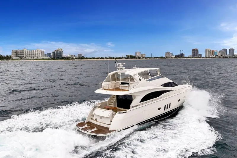 Slide: The Image of Luxury 2007 Marquis 65 yacht cruising near city skyline on a sunny day. - 6