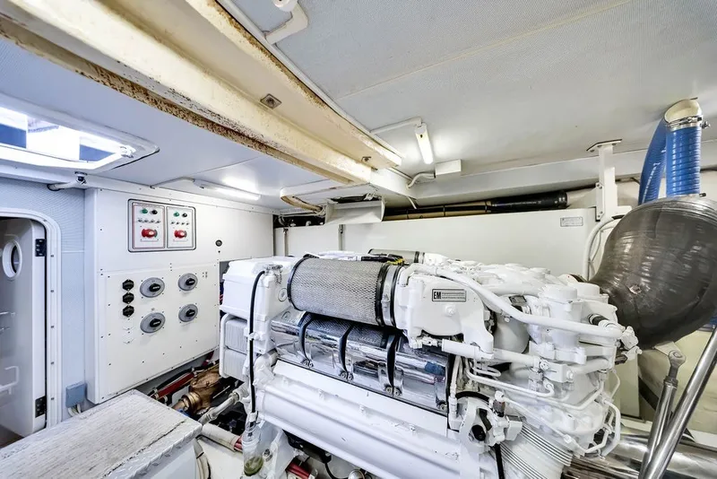 Slide: The Image of Engine room of a 2007 Marquis 65 yacht, featuring a clean, organized layout. - 66