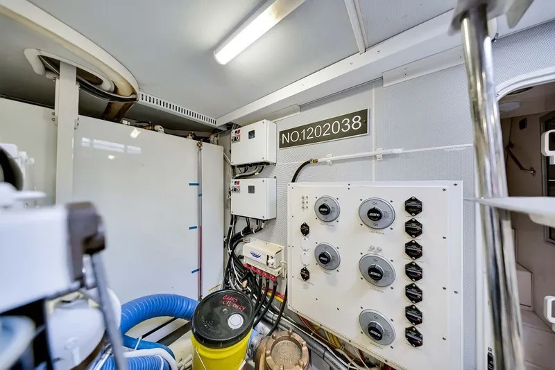 Slide: The Image of Engine room of a 2007 Marquis 65 yacht, featuring control panels and equipment. - 64