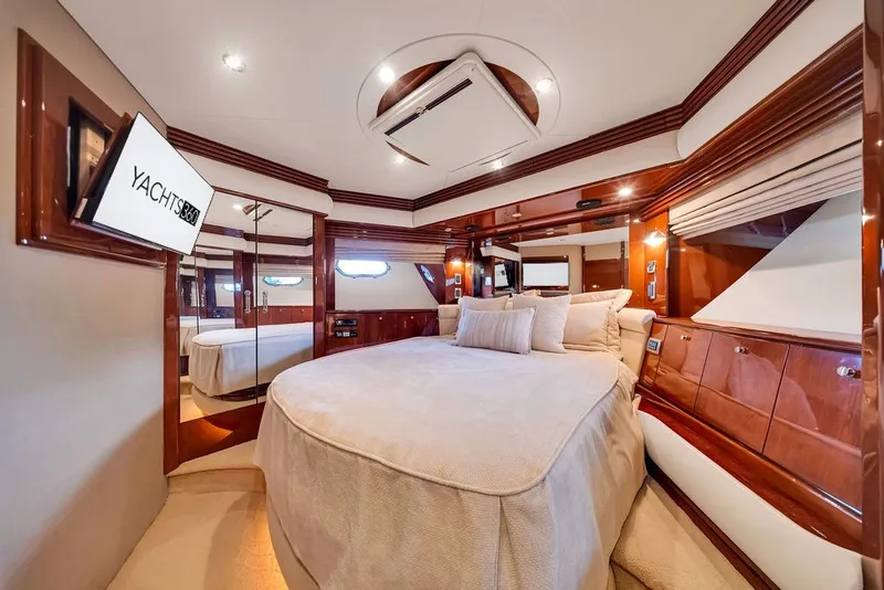 Slide: The Image of Luxurious bedroom interior of 2007 Marquis 65 yacht with elegant wood finishes and plush bedding. - 50