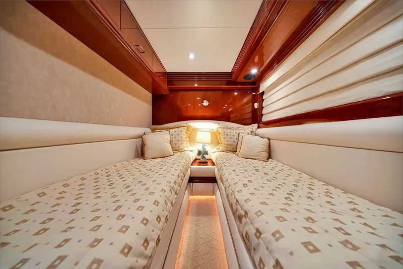 Slide: The Image of Luxurious 2007 Marquis 65 yacht cabin with twin beds and elegant wood finish. - 59