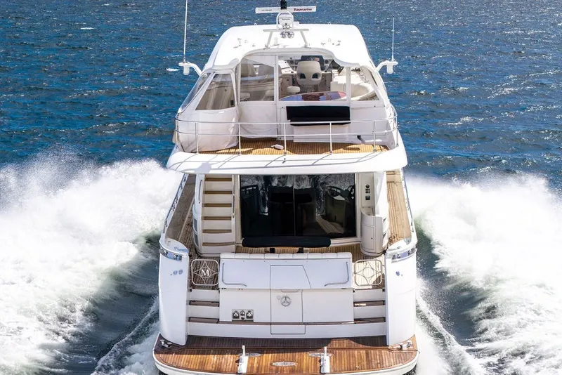 Slide: The Image of Luxury 2007 Marquis 65 yacht cruising on open water, showcasing elegant design and spacious decks. - 10