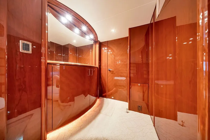 Slide: The Image of Luxurious wood-paneled interior of a 2007 Marquis 65 yacht, featuring elegant lighting and cabinetry. - 35