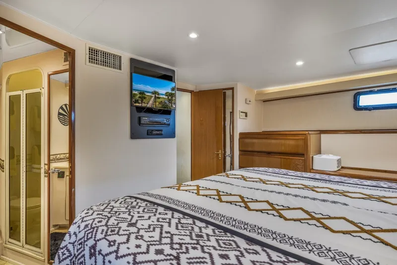 Slide: The Image of Luxurious bedroom interior of 1999 Viking 60 Cockpit Motor Yacht with modern amenities. - 29
