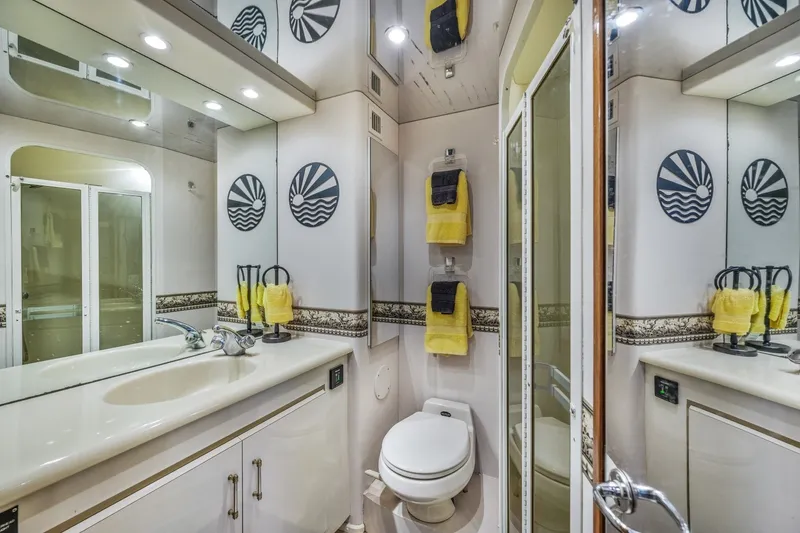Slide: The Image of Luxurious bathroom in a 1999 Viking 60 Cockpit Motor Yacht with elegant fixtures and decor. - 32
