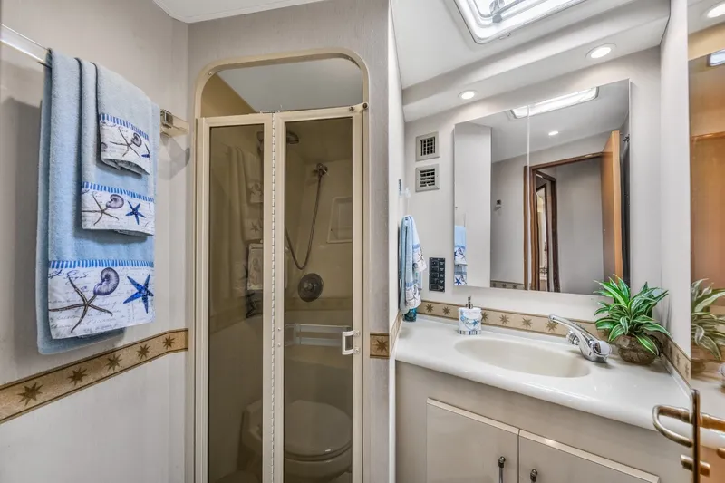 Slide: The Image of Bathroom interior of 1999 Viking 60 Cockpit Motor Yacht with shower and vanity. - 27
