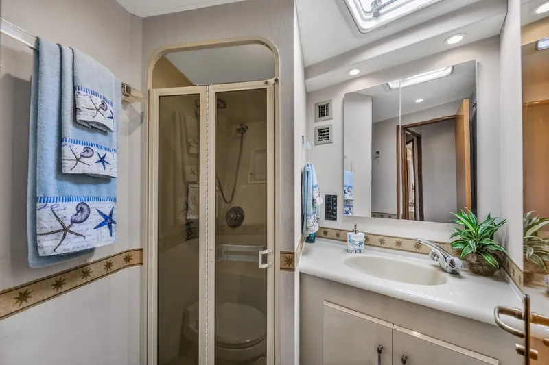 Slide: The Image of Bathroom interior of 1999 Viking 60 Cockpit Motor Yacht with shower and vanity. - 31