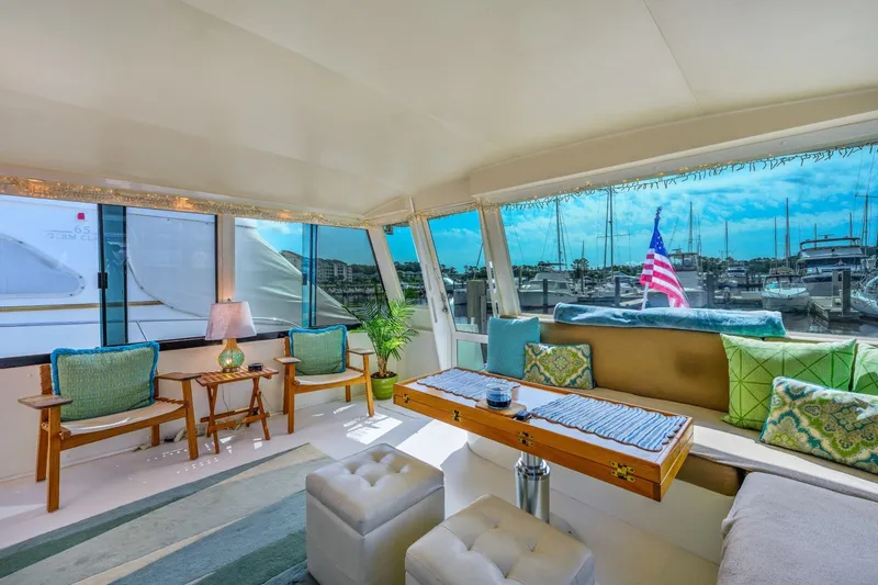 Slide: The Image of Luxurious interior of 1999 Viking 60 Cockpit Motor Yacht with marina view. - 13