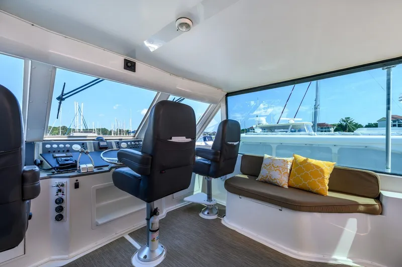 Slide: The Image of Interior of 1999 Viking 60 Cockpit Motor Yacht with helm and seating area. - 10