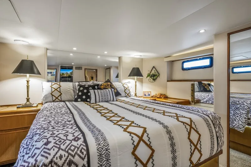Slide: The Image of Luxurious bedroom interior of 1999 Viking 60 Cockpit Motor Yacht with elegant decor. - 28