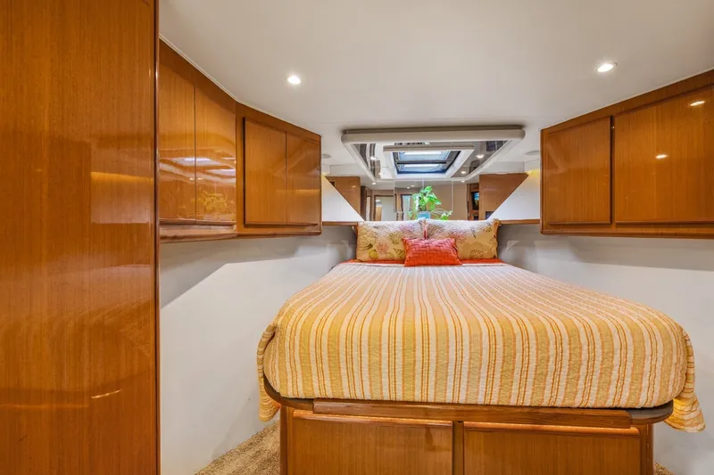 Slide: The Image of Luxurious cabin interior of a 1999 Viking 60 Cockpit Motor Yacht with wood cabinetry. - 24