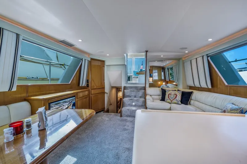 Slide: The Image of Luxurious interior of 1999 Viking 60 Cockpit Motor Yacht with elegant seating and decor. - 15