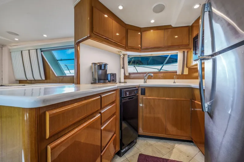 Slide: The Image of Luxurious kitchen interior of 1999 Viking 60 Cockpit Motor Yacht with modern appliances. - 21