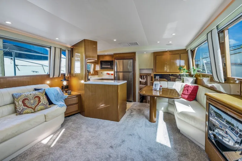 Slide: The Image of Luxurious interior of 1999 Viking 60 Cockpit Motor Yacht with modern furnishings and ample natural light. - 14