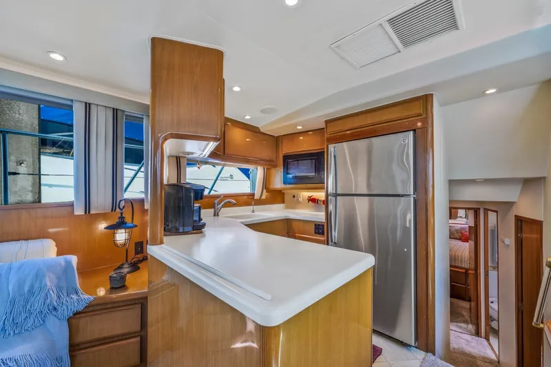 Slide: The Image of Interior of 1999 Viking 60 Cockpit Motor Yacht with modern kitchen amenities. - 20