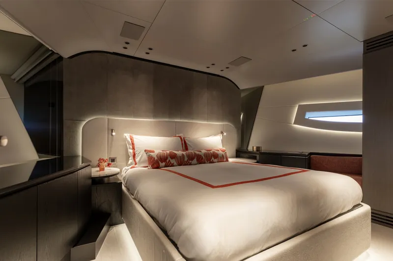 Slide: The Image of Luxurious bedroom interior of 2024 Mangusta 104 REV yacht, featuring modern design and ambient lighting. - 38