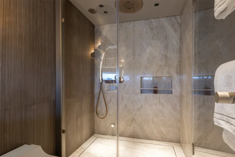 Slide: The Image of Luxurious shower area in 2024 Mangusta 104 REV yacht, featuring elegant marble and modern fixtures. - 35