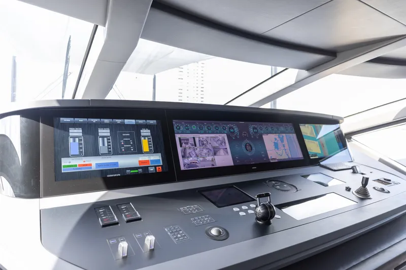 Slide: The Image of Control panel of 2024 Mangusta 104 REV yacht, featuring advanced navigation displays and controls. - 48