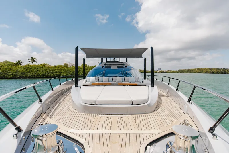 Slide: The Image of 2024 Mangusta 104 REV yacht with sleek deck design on tranquil water. - 65