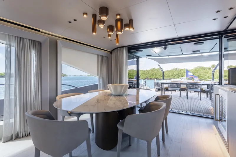 Slide: The Image of Luxurious interior of 2024 Mangusta 104 REV yacht with elegant dining area and scenic views. - 18