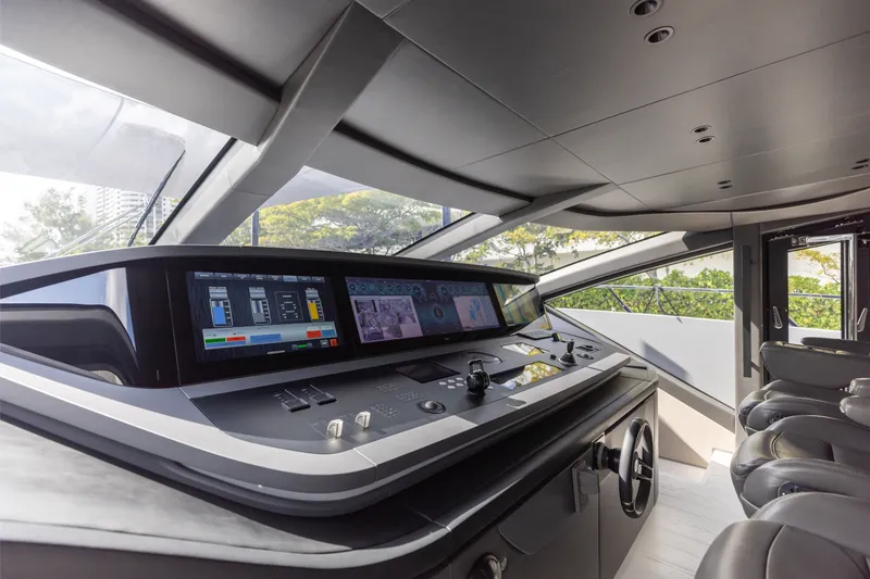 Slide: The Image of 2024 Mangusta 104 REV yacht cockpit with advanced navigation controls and sleek design. - 50