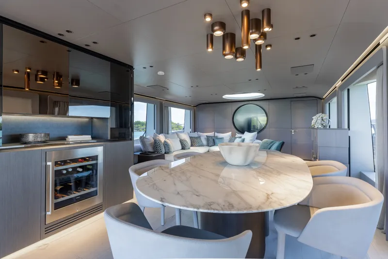 Slide: The Image of Luxurious interior of 2024 Mangusta 104 REV yacht with elegant dining area and modern decor. - 17